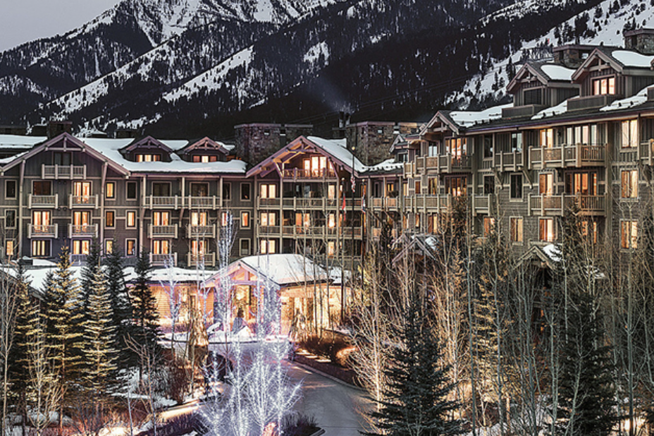 Suggested venue lodge lit up against a snowy mountain at dusk
